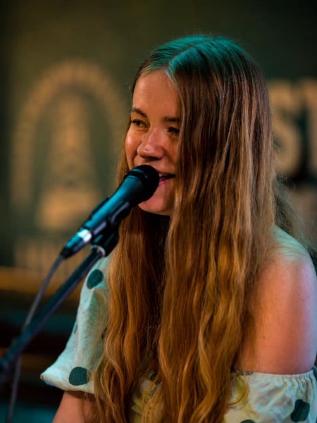 Jess Martyn singing into the microphone, close up